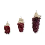 Three decorative piquin chile regalitos on a white background