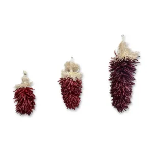 Three decorative piquin chile regalitos on a white background